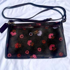 Coach crossbody bag with floral accents and extra pouch